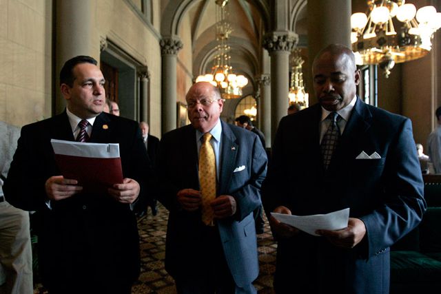 Photograph of Senators Hiram Monserrate, Carl Kruger, and Eric Adams by Mike Groll. The Senators are holding bills, which were passed by the Democrats, that they want signed by Governor Paterson.